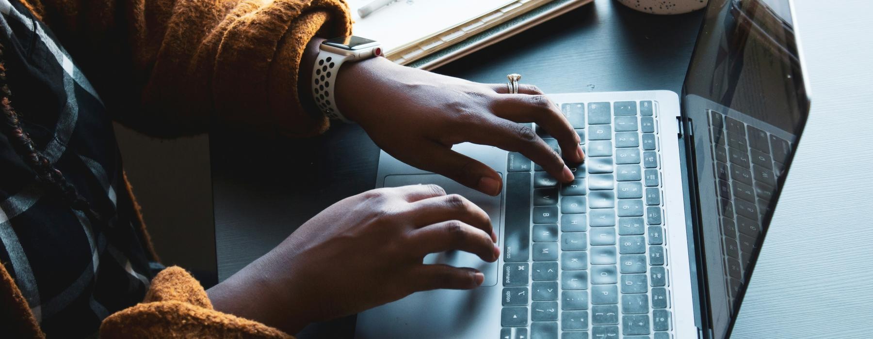 a person typing on a laptop