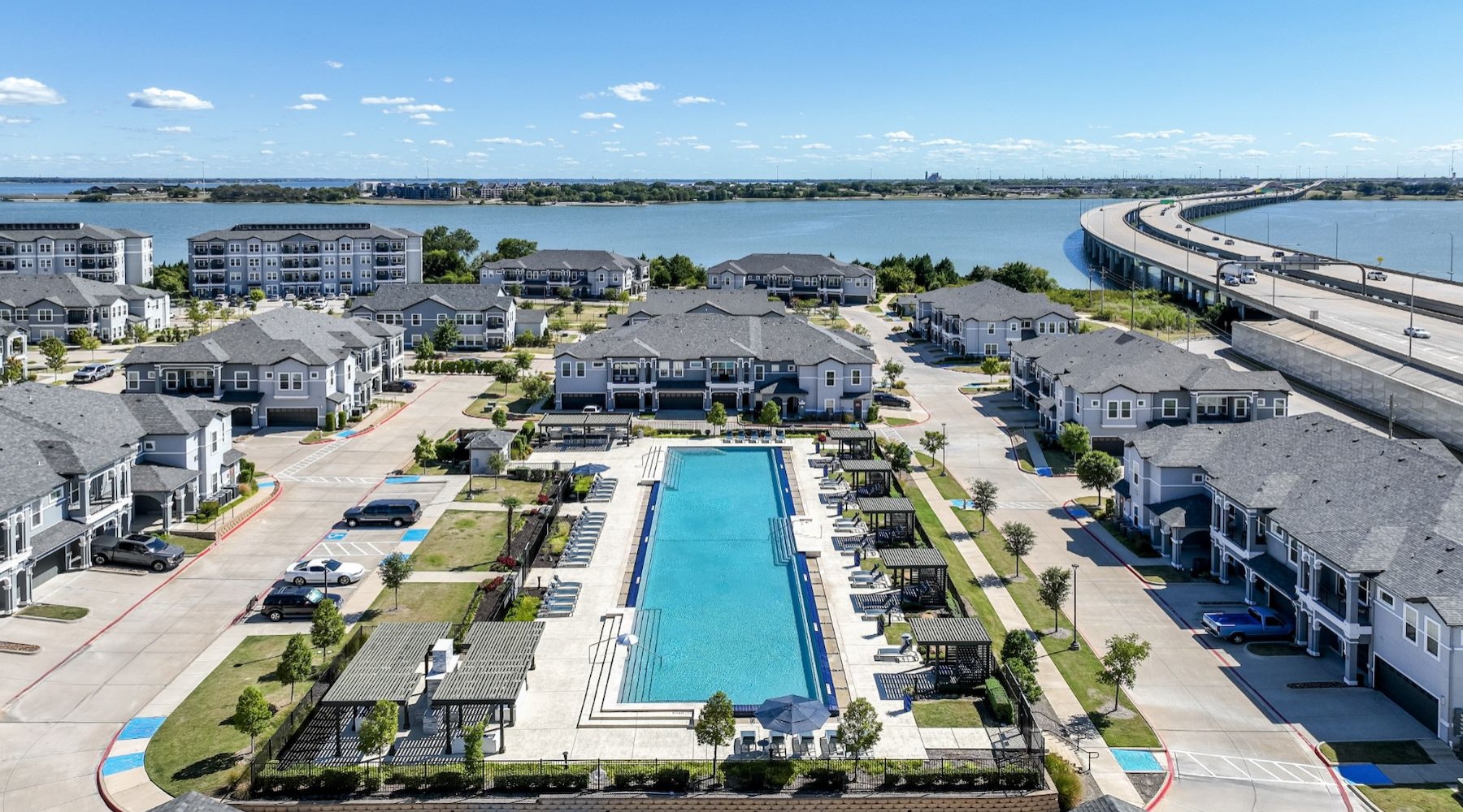 large resort-style pool with a large body of water in view