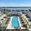 large resort-style pool with a large body of water in view