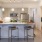 a kitchen with a bar stools and serving counter