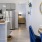 a kitchen with a dining table and a mirror